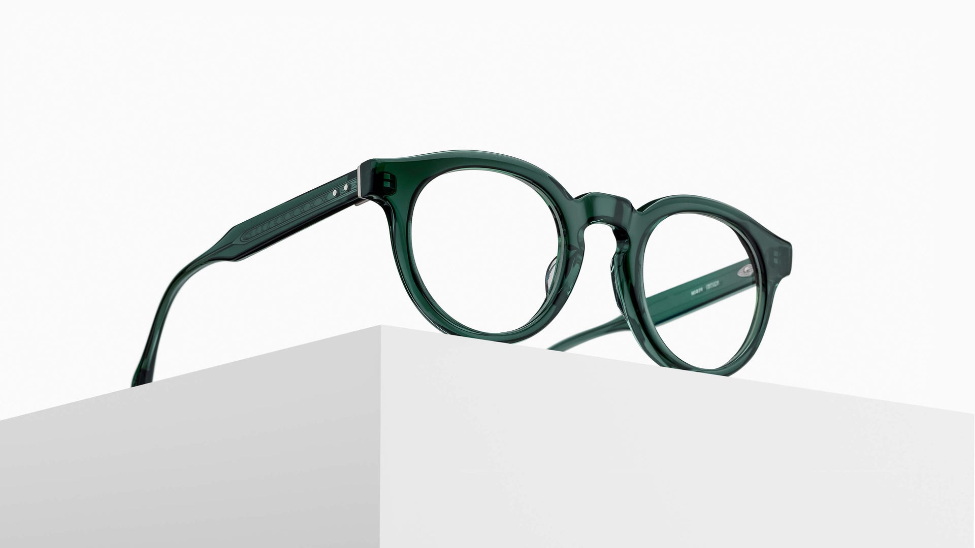 Forest green Matsuda M1039 optical frame resting on a white plinth